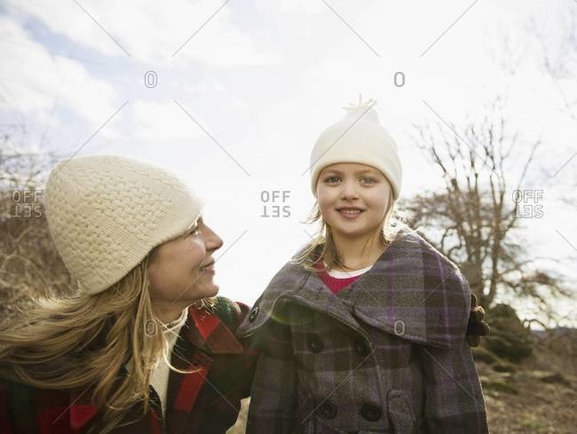 A woman and child wrapped up against the cold weather.