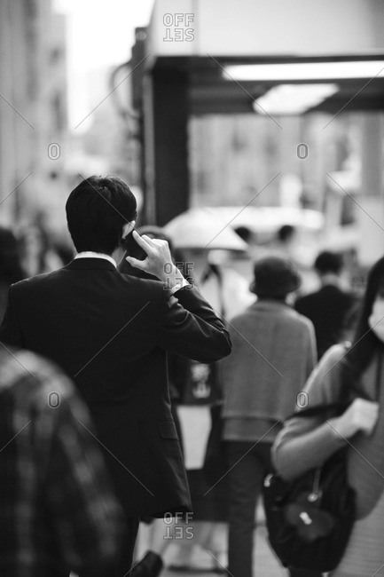 Back view of businessman talking on his cell phone, Ginza district in Tokyo, Japan