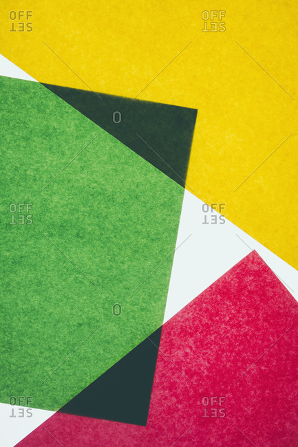Pieces of colorful, recycled construction paper, overlapping and laid out at random.