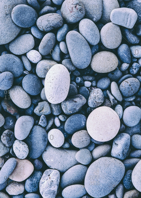 Polished smooth stones and pebbles on the sea shore, in Olympic national park.  Varied shapes and sizes.