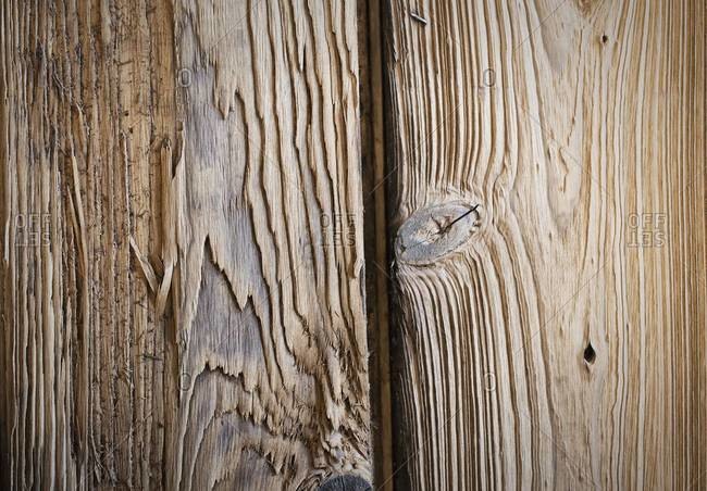 Close up of two planks of wood, with knots and wood grain patterns