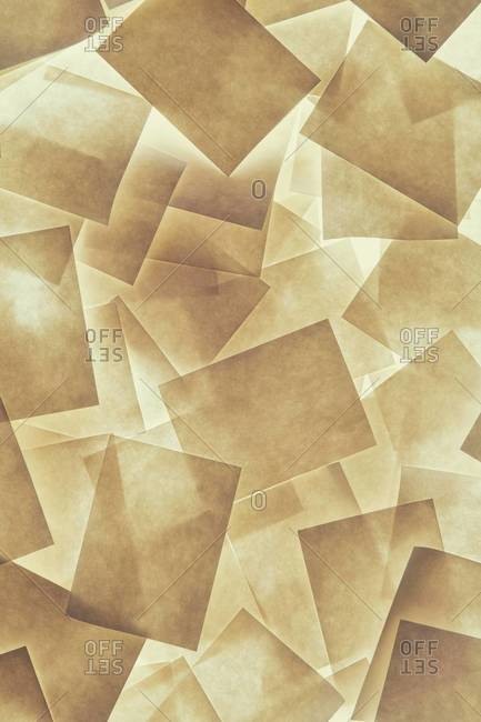 Post it notes arranged and overlapping, above a light source