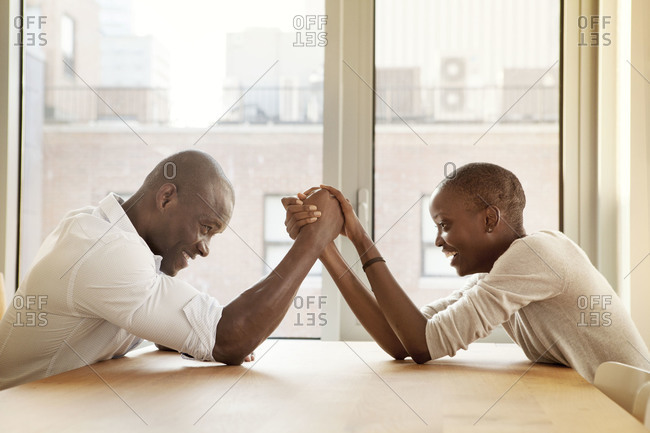 African American couple arm wrestling