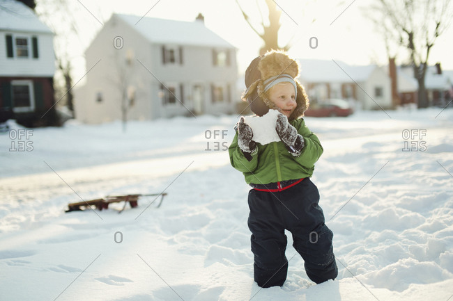 Young boy playing the snow