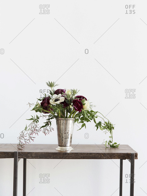 Bouquet of flowers in brass vase on table