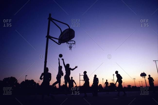 Group of young men playing street basketball, Louisiana
