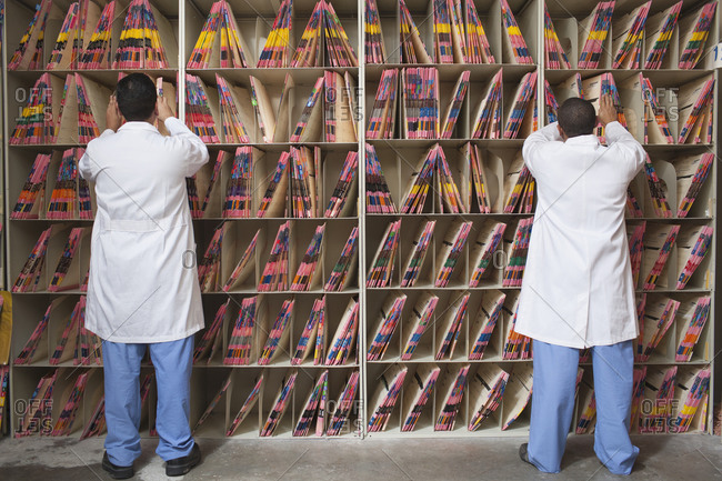 Doctors sorting medical files in hospital