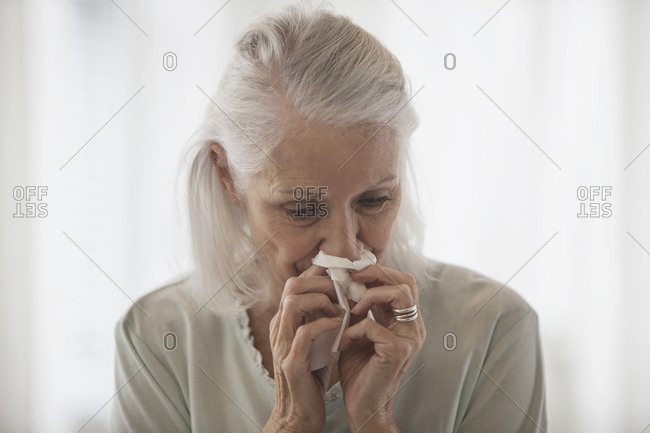 Senior Woman blowing her nose