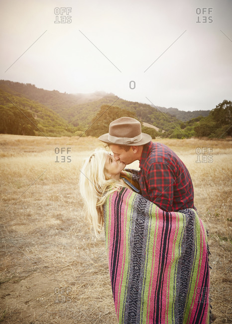 Couple kissing in rural landscape