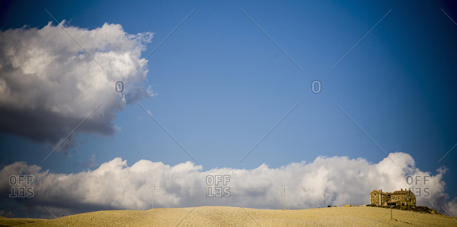 Clouds rolling over estate in rural landscape