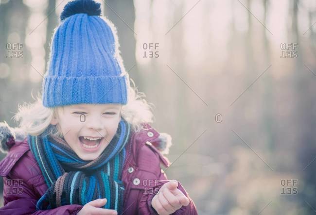 Laughing boy wearing blue woolly hat