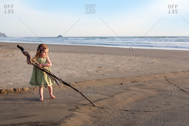 Young girl draw a line in the sand