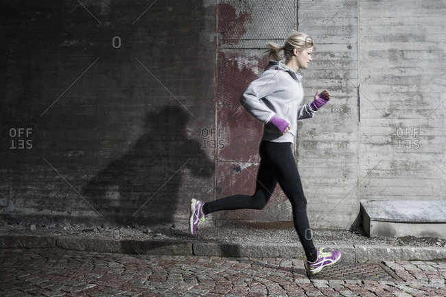Full length of woman jogging on street