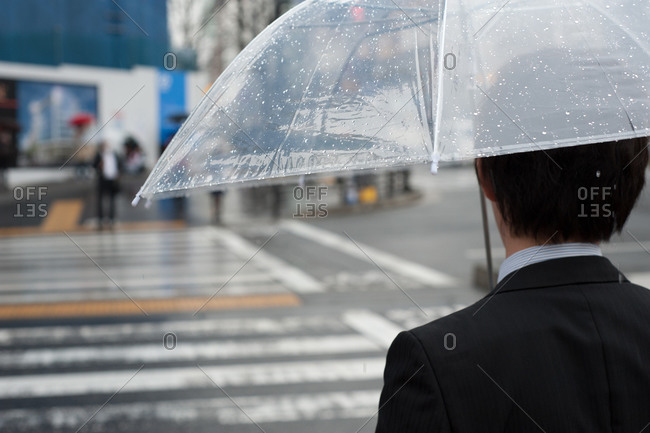 Japanese businessman under the rain in Aoyama, Tokyo, Japan