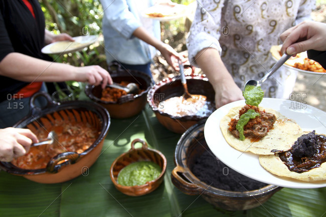 People self serving food at a garden party