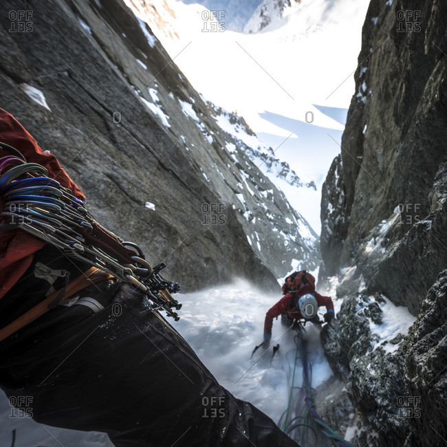 Alpinist comes to the third belay in the Modica-Noury ice gully, Mont Blanc du Tacul
