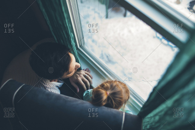 Man looking at window together with young girl