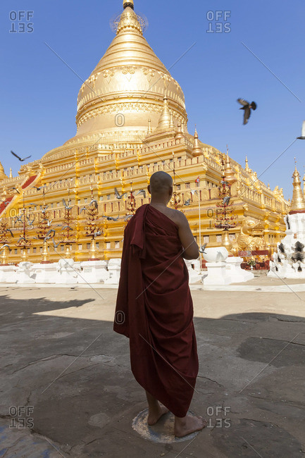 Monk standing in special prayer spot, Shwezigon Pagoda, Bagan (Pagan), Myanmar, (Burma)