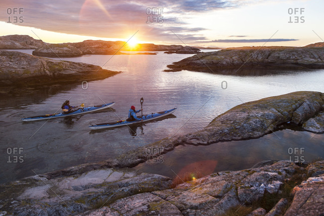 People kayaking at sunrise in Fjallbacka, Bohuslan, Sweden