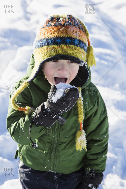 Boy checking taste of snow