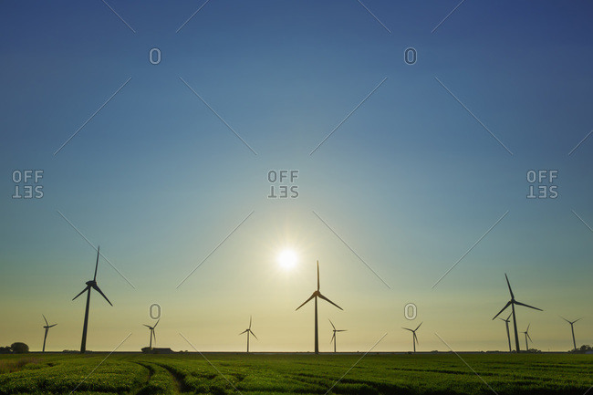 Wind energy plant and sun -  Germany, Schleswig-Holstein, North Frisia, Niebuell