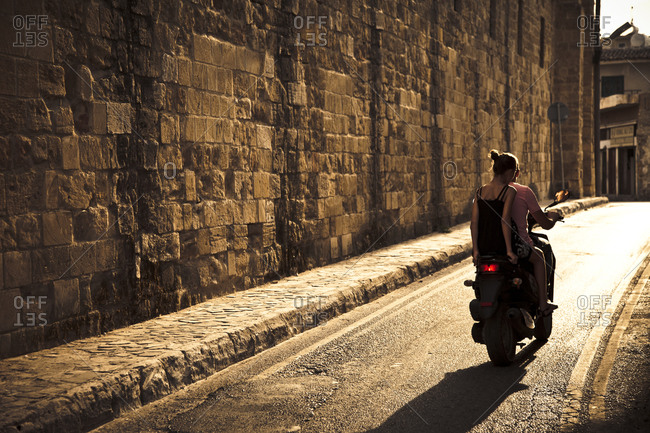 Couple rides on motorcycle in the old section of Nicosia, Northern Cyprus