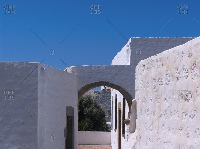 Whitewashed building under a clear blue sky