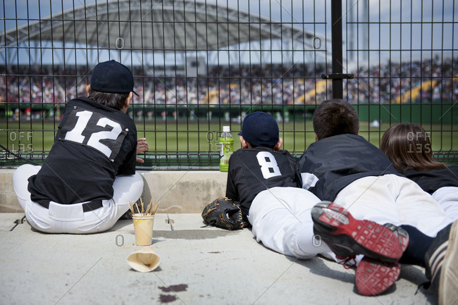 Children watching a game at a baseball field