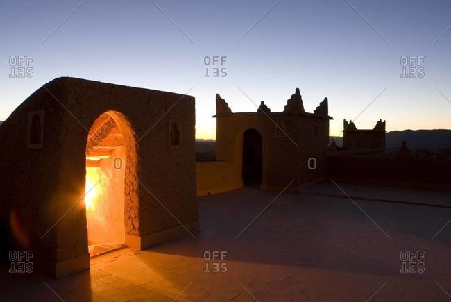 Roof terrace at dawn on a kasbah in the town of Nkob, with light glowing from the staircase, Nkob, Morocco