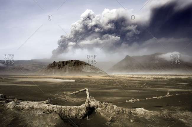 Landscape covered in volcanic ash and dust with the ash plume of the Eyjafjallajokull eruption in the distance, southern area, Iceland, Polar Regions