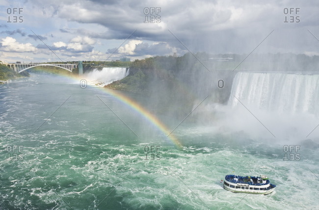 Maid of the Mist tour excursion boat under the Horseshoe Falls waterfall with rainbow at Niagara Falls, Ontario, Canada, North America