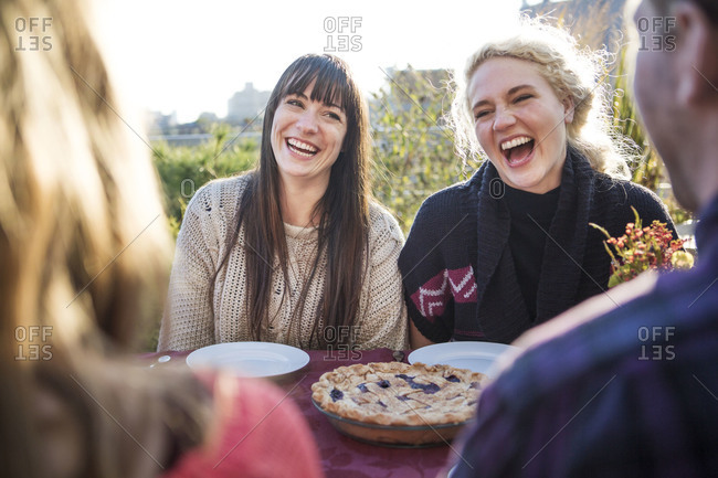 Laughing friends eating pie