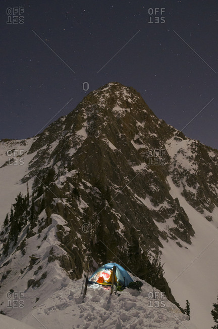 A man camping at night below the Pfeiffferhorn in Lone Peak Wilderness, Salt Lake City, Utah.