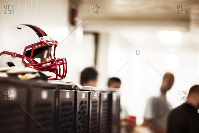 Football helmet in a locker room