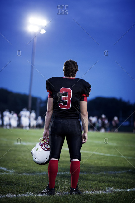 Football player standing at a field