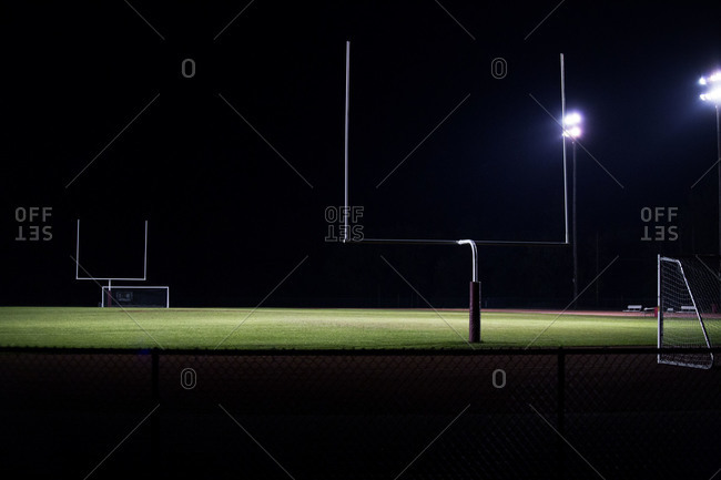 Empty football field lit up at night