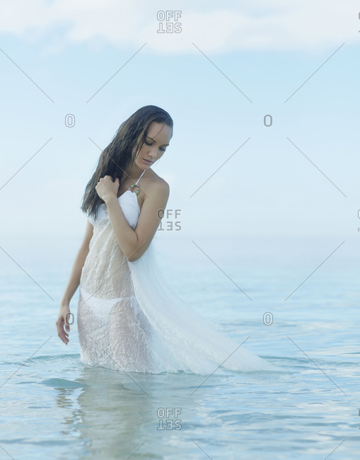 Pacific Islander woman standing in ocean