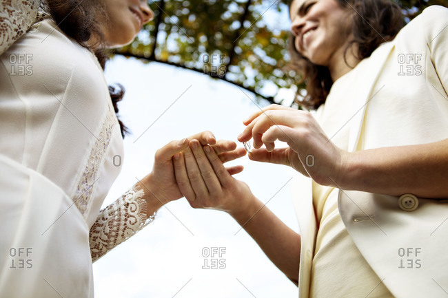 Lesbian couple exchanging rings at their wedding ceremony