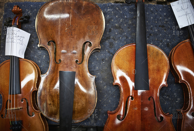 Violins to be repaired in a violin maker\'s workshop