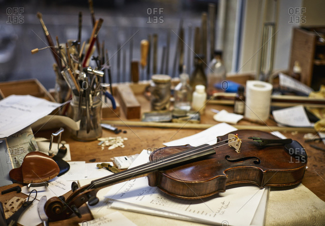 Tools and damaged instruments in a violin maker\'s workshop