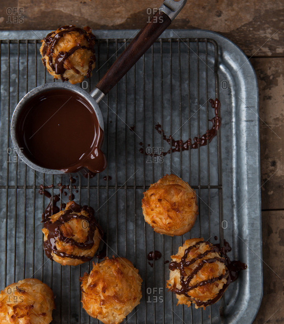 Drizzling coconut macaroons with melted chocolate
