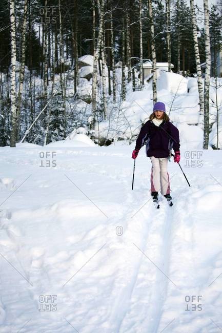 Ten year old girl cross-country skiing, Finland, Scandinavia, Europe