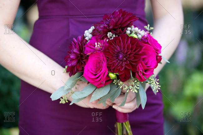 Bridesmaid holding a purple wedding bouquet
