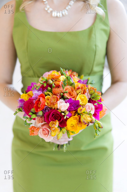Bridesmaid holding colorful wedding bouquet