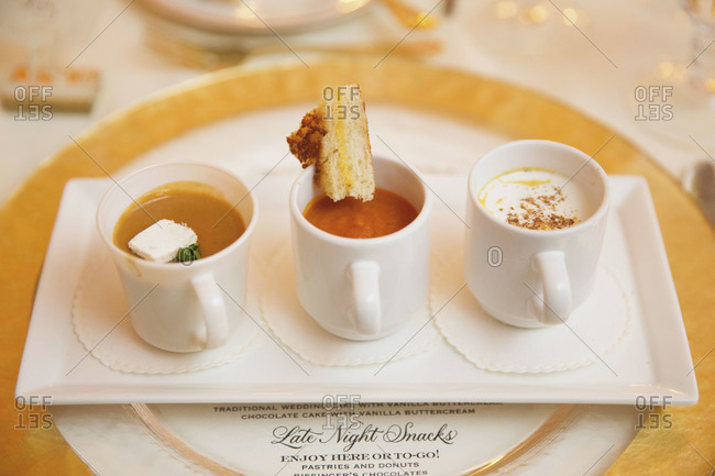 Three soups served in cups at wedding reception