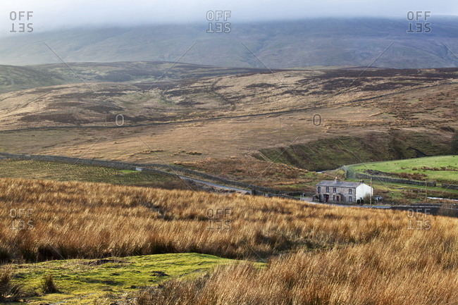 Isolated house by the road in Garsdale below Baugh Fell, Yorkshire Dales, Cumbria, England, United Kingdom, Europe