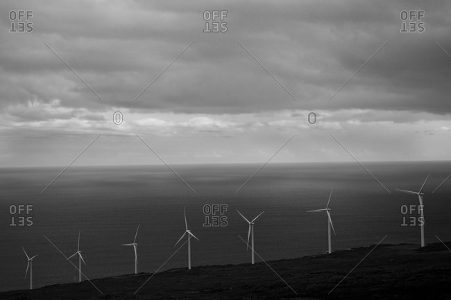 Wind turbines with an ocean in the background