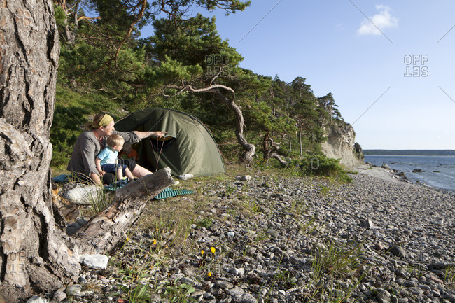 Mother with son camping on beach