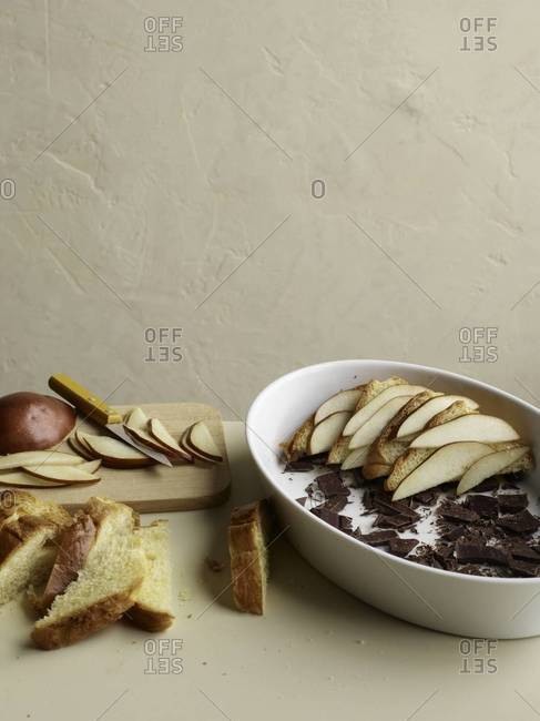 Preparing pear and chocolate brioche bread pudding