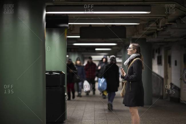 Woman standing in a subway